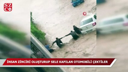 Akçakoca ilçesinde, ele ele tutuşanlar sel sularında yüzen otomobili tutarak garaja çekti