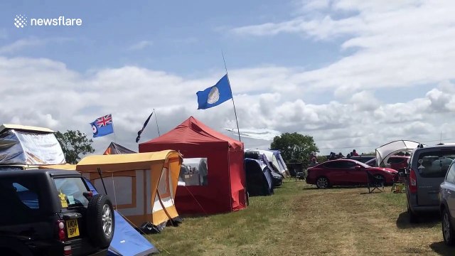 Flypast of a 747 in historic BOAC livery, alongside the Red Arrows