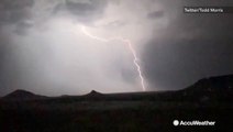 Bolts of lightning leap from the clouds during nighttime thunderstorm