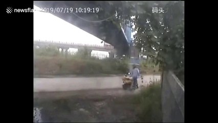 Truck trailer narrowly misses man after smashing into bridge in China