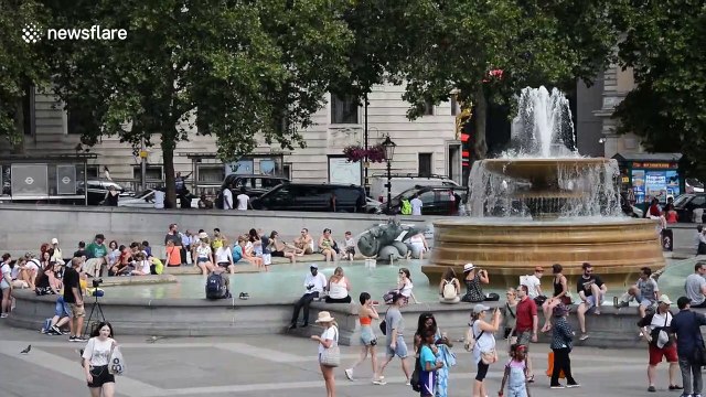 Locals and tourists cool off in London's fountains as blistering heatwave continues