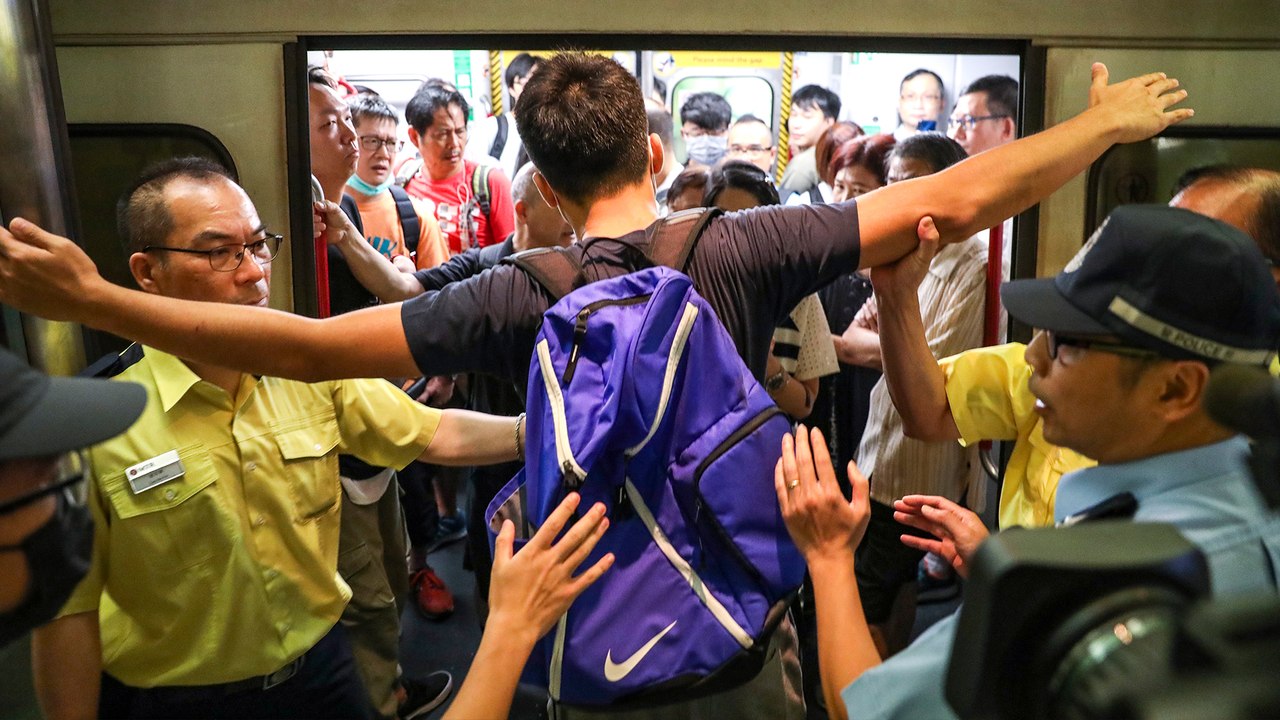 Protesters block subway trains causing massive delays during Hong Kong rush hour