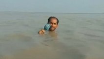 Pakistani reporter stands neck-deep in water to deliver live report on floods