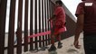 Border becomes backyard as Mexican kids and US playmates see-saw through fence