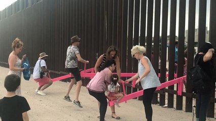 Watch: Mexican and American children play across border wall on pink seesaws