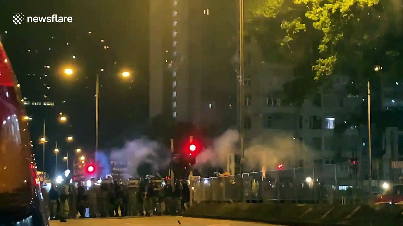 Masked youths in Hong Kong throw bricks and glass bottles at riot police