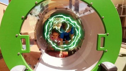 Little Mia and her brother playing in outdoor playground for children. Kids entertainment Part 2