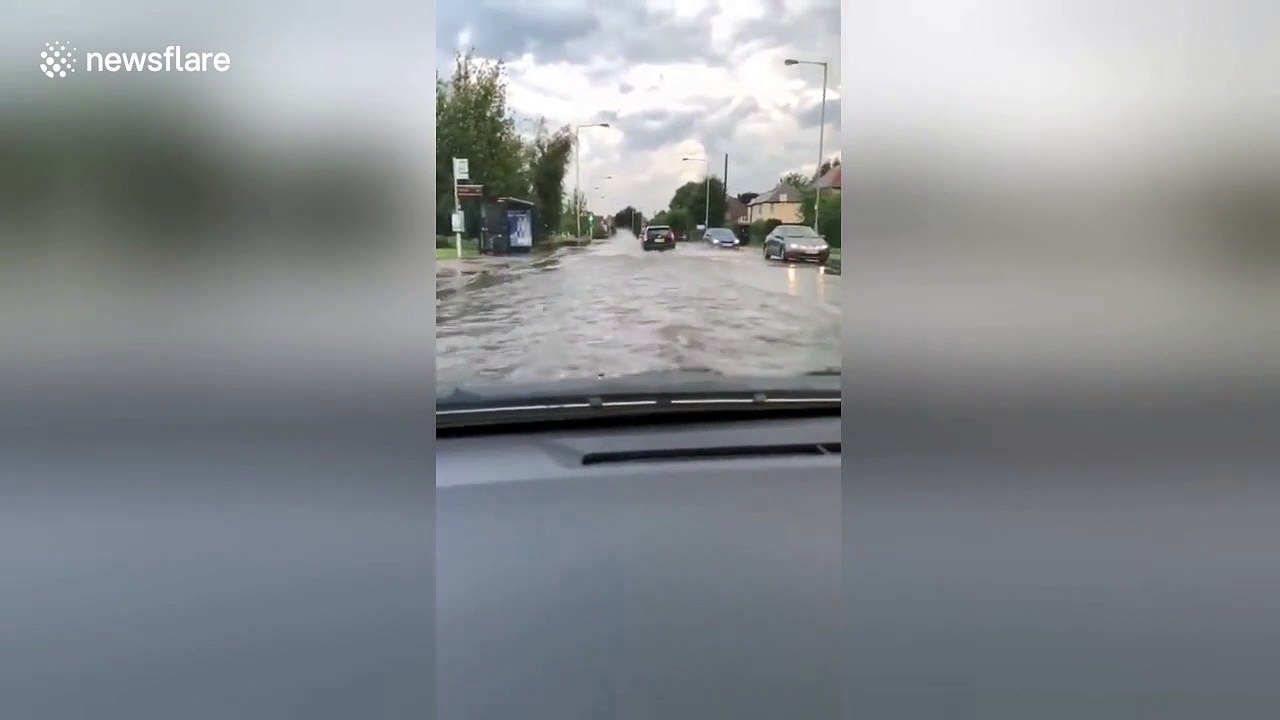 Cars plough through submerged Nottingham road after flooding