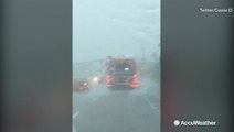 Torrential rainfall makes it hard for motorists to drive through this highway