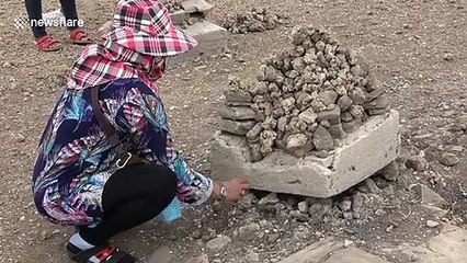 Thai locals flock to sunken Buddhist temple that has emerged from the water after severe drought