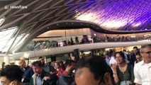 During a London power outage hundreds of commuters pile out of Kings Cross station