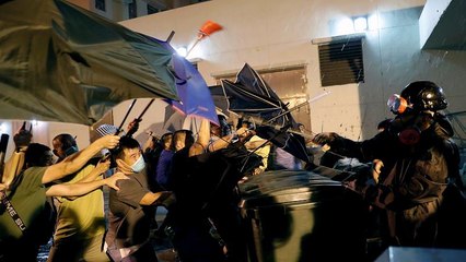 Terelőkúppal védekező hongkongi tüntetők