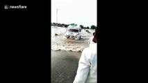Brave boy guides ambulance by running though flood waters