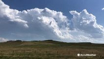 Clouds tower above countryside as storms begin to gather