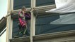 'French Spider-Man' Alain Robert climbs Hong Kong skyscraper and unveils peace banner