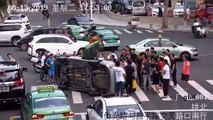 Passersby join forces to rescue people trapped beneath taxi