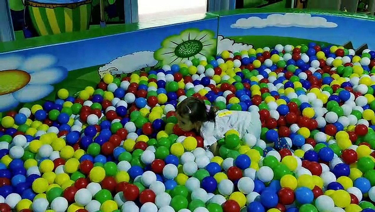 Little Mia on kids playground playing on slide and playing kitchen. Kids entertainment