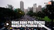 Hong Kong protesters throng streets peacefully in pouring rain
