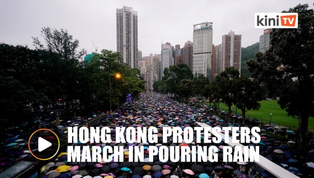 Hong Kong protesters throng streets peacefully in pouring rain
