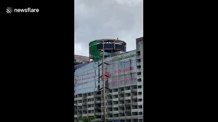 Demolition worker spotted swinging sledgehammer at 12-storey apartment block in Thailand