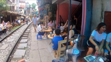 Tourists warned as they set up cafes inches from speeding train dubbed 'death rails'
