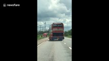 Broken bus drives diagonally on Thai motorway