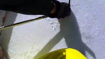 Skier Slides in Free-Fall Down Icy Slope