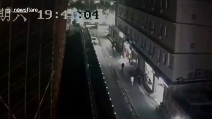 Wind blows over metal fence narrowly missing car driving past in southern China