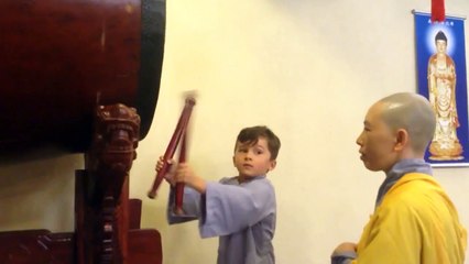 Boy drumming at Buddhist Temple