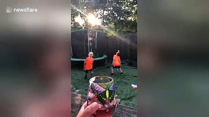 Genius mother puts donuts on a string to distract sons while she sips red wine in Kansas backyard