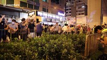 Hong Kong police take cover behind netting and riot shields