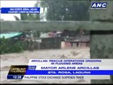 Laguna residents scale rooftops, flee floods