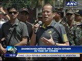Aquino visits evacuees at Zamboanga sports complex