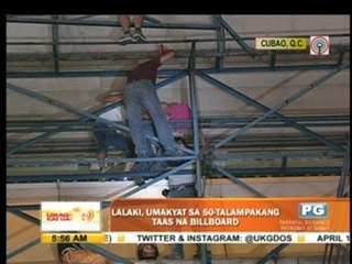 Man scales billboard in Cubao