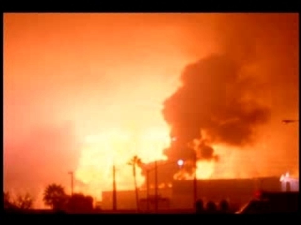 Wide shot Dunes HotelCasino imploding and falling with smoke