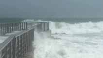 Violent waves crash into pier