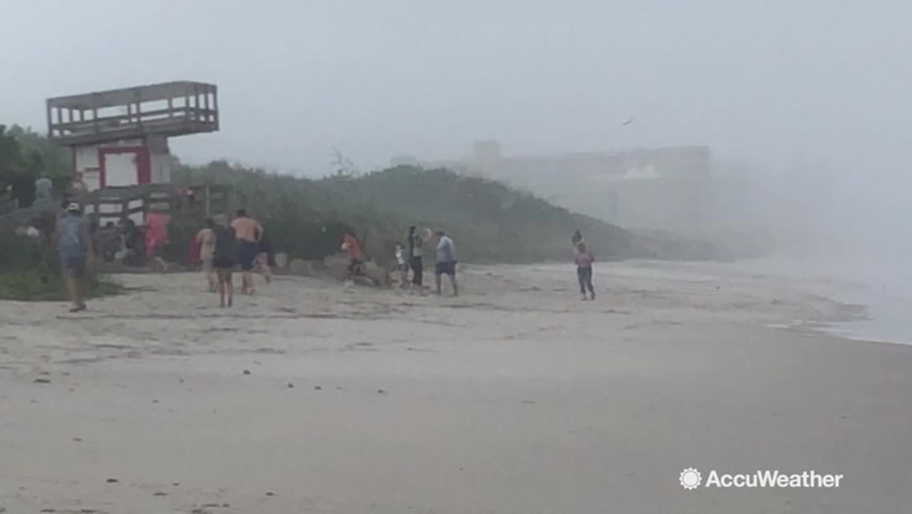 Beachgoers run for cover from squall