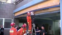 Firefighters in China rescue boy who got his head trapped in garage's roller shutter