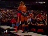 WWE - Kurt Angle belly to belly suplexes HHH off one table o
