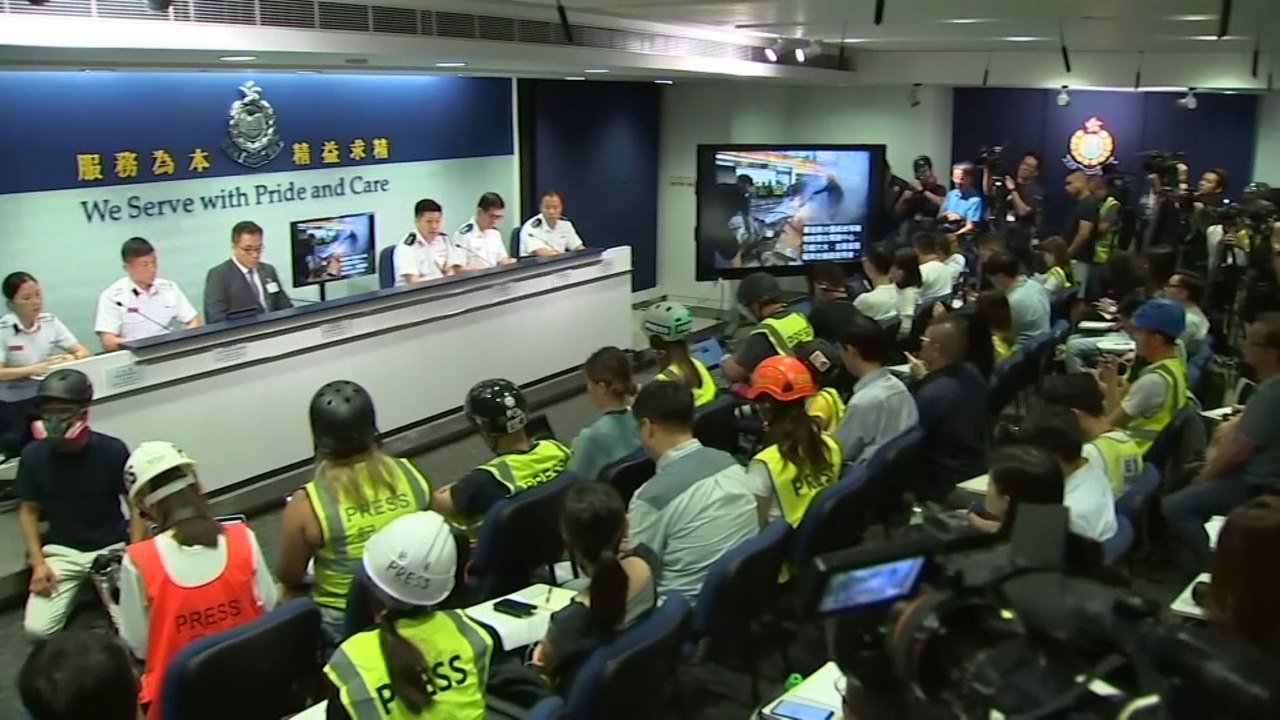 Journalists wear safety gear to Hong Kong polic...