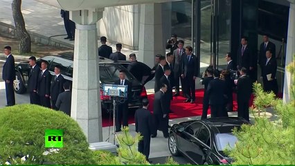 Men in Black_ Kim's bodyguards run by his limo during summit