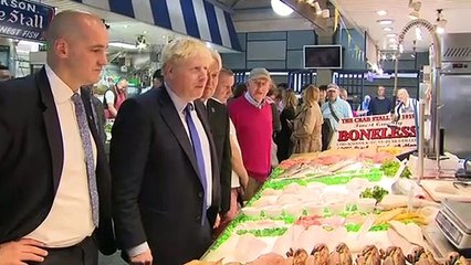 Boris Johnson buys a pound of plums at Doncaster Market