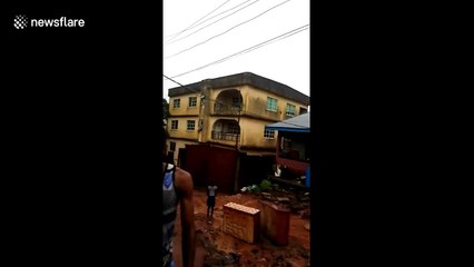 Shocking moment three-storey block collapses in Nigeria after downpour