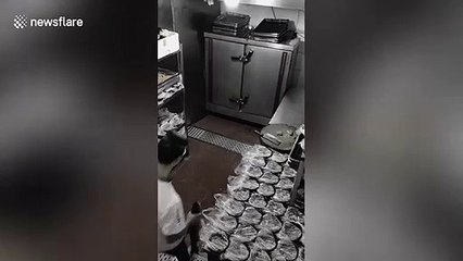 Chinese cook struggles to find fish that flew out of his hands as he slipped over