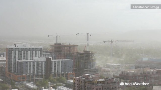Construction cranes sway as gusty Arizona dust storm whips through town