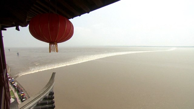 Mid-Autumn Festival moon drives spectacular tidal waves in China’s Zhejiang province attracting surfers and tourists