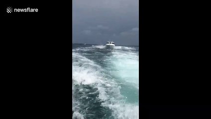 Speedboat races through choppy seas to avoid approaching storm