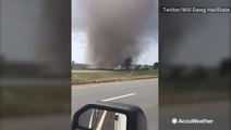 Massive dust devil sweeps onto road