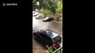 Waterlogged cars struggle to drive on flooded Houston roads
