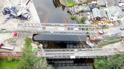 Large construction operation sees bridge lifted by crane over UK river